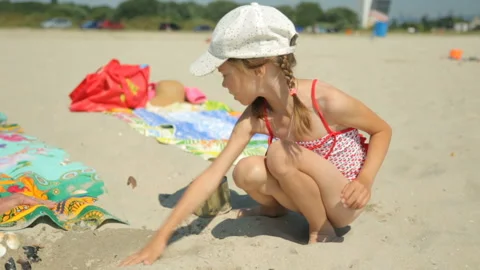 Child playing with sand on beach Stock Footage 96354442