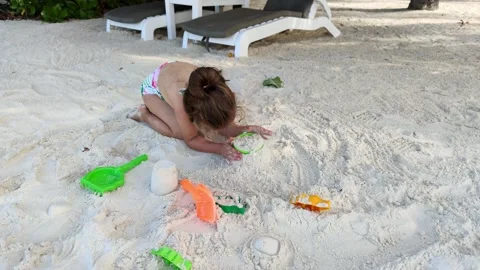 Child playing with sand on beach ocean sea. Child sculpt from the sand. 스톡 동영상 168402428