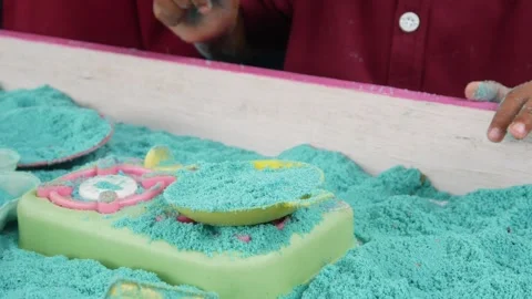 Child playing in the sand. Close-up of a boy's hand playing with turquoise sand. Stock Footage 306774727