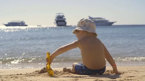 The child is playing in the sand. Stock Footage 83683068