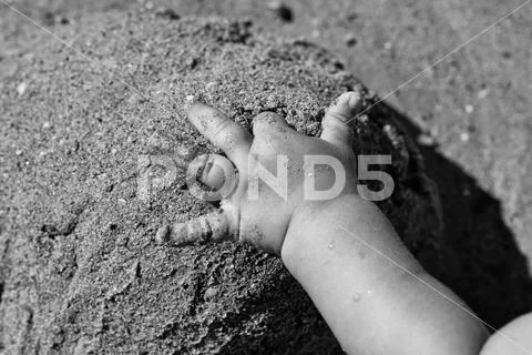 Child is playing with the sand. Hand of child on sand Stock Photos