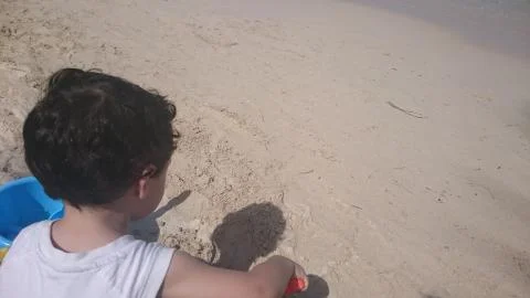 A child playing in the sand Stock Photos