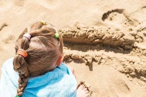 Child is playing in the sand Stock Photos