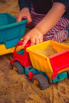 Child is playing in the sand Stock Photos