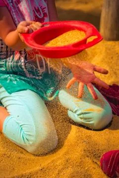 Child is playing in the sand Stock Photos