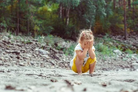 Child playing on the sand Stock Photos