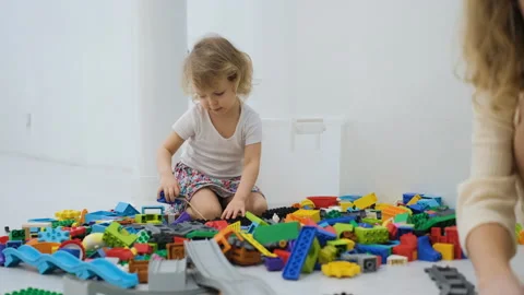 Child playing with scattered building blocks Stock Footage 335425343