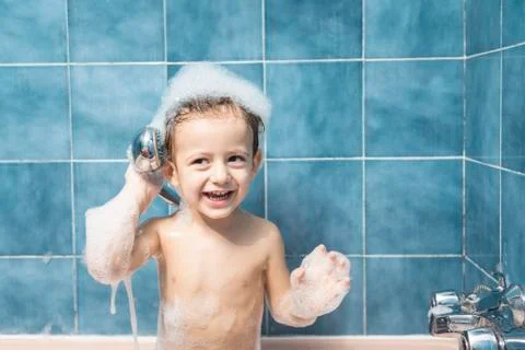 Child playing with the shower head Stock Photos