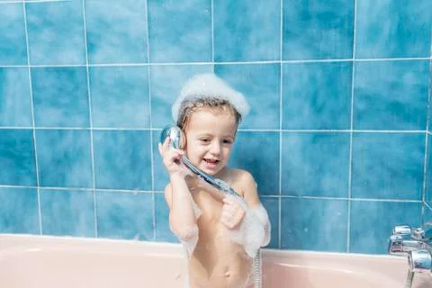 Child playing with the shower head Stock Photos