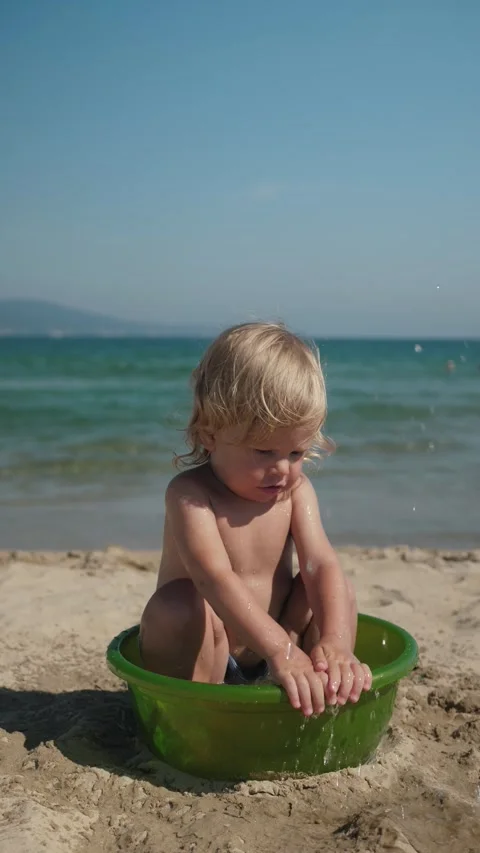 Child playing in small basin at seaside Stock Footage 316424853