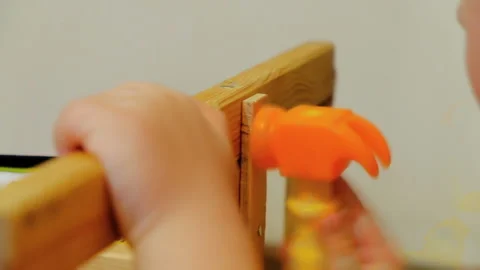 Child playing with a small toy hammer. Repair chair 스톡 동영상 86076083