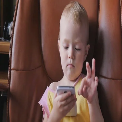 Child playing with smart phone Stock Footage 69689767