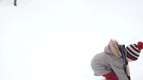 Child playing in the snow in winter Stock Footage 278825873