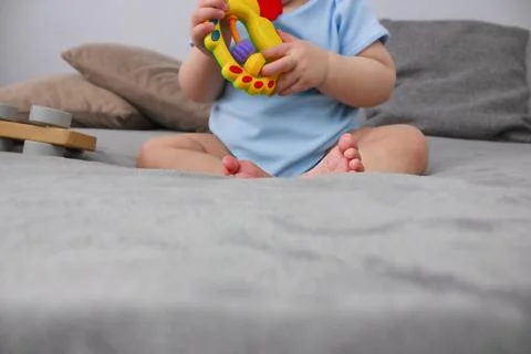 Child is playing on the sofa. Copy space. Selective focus. Stock Photos