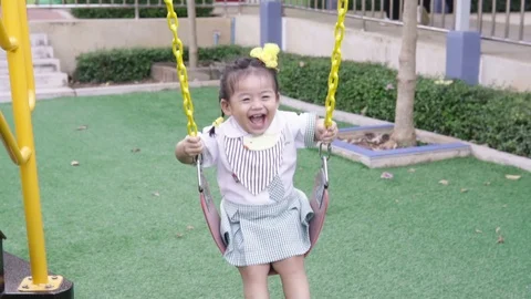 Child playing on the swing at the park Stock Footage 87660299