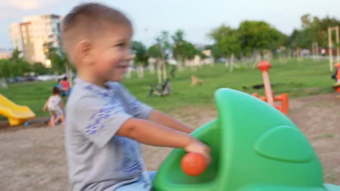 The child is playing on a swing at the playground. Stock Footage 282790913