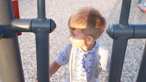 The child is playing on a swing at the playground. Stock Footage 282790970