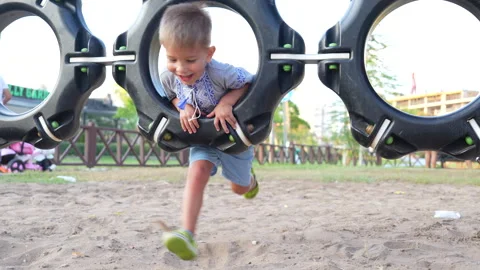 The child is playing on a swing at the playground. Stock Footage 282791057