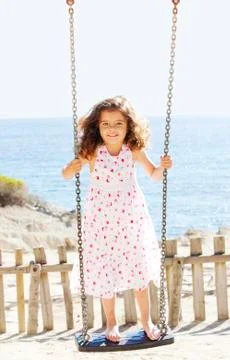 Child playing swing on vacation Stock Photos
