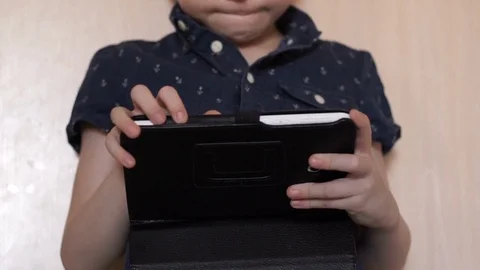 A child is playing a tablet Stock Footage 74970289