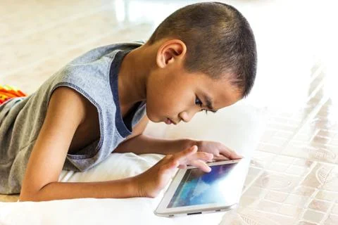Child playing tablet Stock Photos