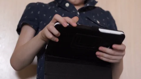 A child is playing a tablet, slow motion Stock Footage 74971224