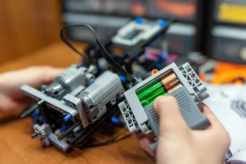 Child playing with technological toy, building robot machine Stock Photos