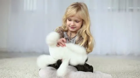 Child playing with a teddy bear Stock Footage 10599999
