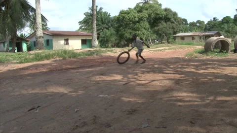 Child playing with tire sequence EXT Liberia 1 Stock Footage 133925061