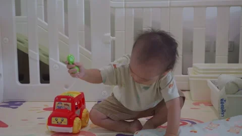 Child Playing with Toy Car in Bright Indoor Environment Stock Footage 341143201