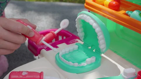 Child playing with toy dentist kit close up Stock-Footage 341242010
