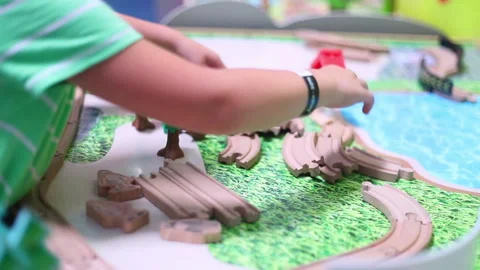 Child playing with toy road on the table Stock Footage 137789173