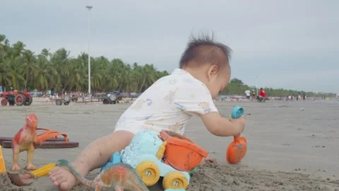 Child Playing with Toys on Beach Stock Footage 341142155
