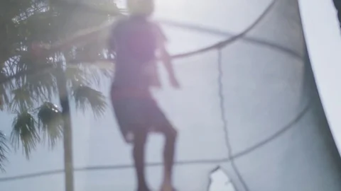 Child playing on trampoline Stock Footage 76726961