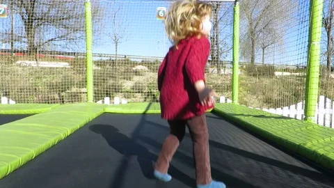 Child playing in trampoline slowmotion Stock Footage 71409925