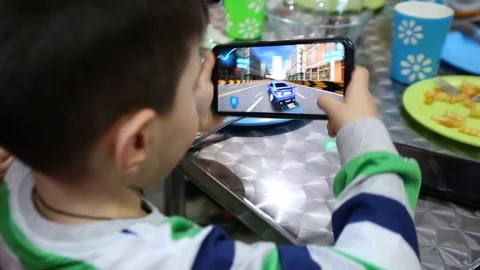 Child Playing Video Game In Cell Phone 库存影片 126703458