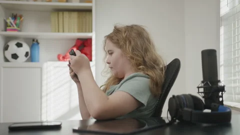 Child playing video game with joystick. Child using game controller playing Stock Footage 346829096