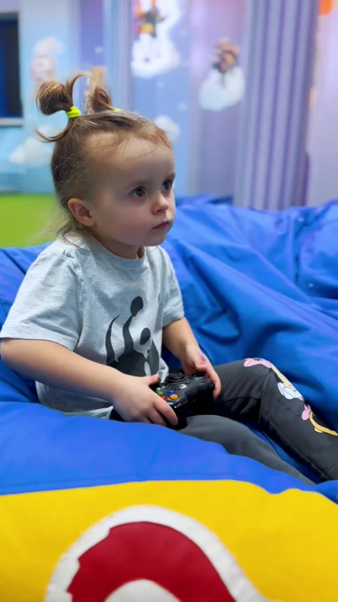 Child Playing Video Games with Controller Indoors Video stock 331748087