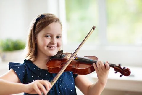 Child playing violin. Remote learning. Stock Photos