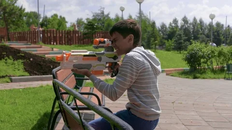 The child is playing in the war. Game on green grass. Summer vacation. Stock Footage 78213280