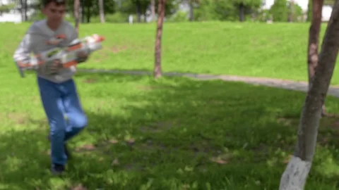 The child is playing in the war. Game on green grass. Summer vacation. Video stock 78213545