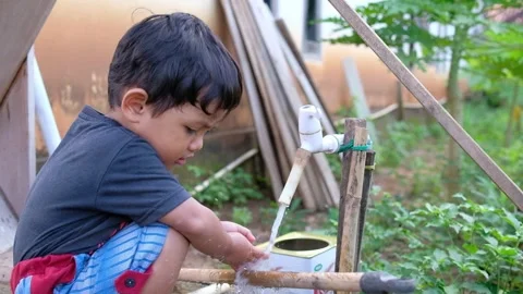 Child playing with water  Stock Footage 244214081