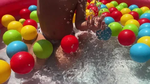  The child is playing with water in an inflatable pool Stock Footage 245930227