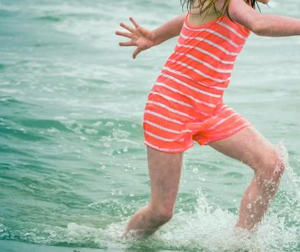 Child Playing In The Waves Fotos de archivo