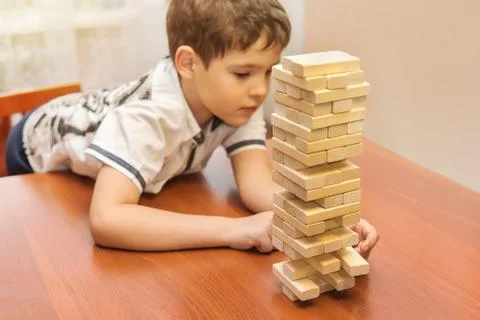 A child playing wood blocks stack game Stock Photos