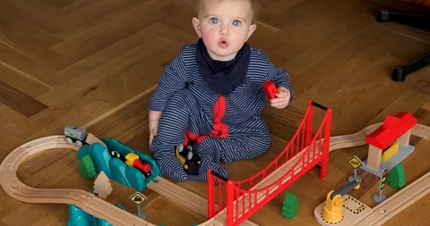 Child playing with wooden train Stock Footage 106796902