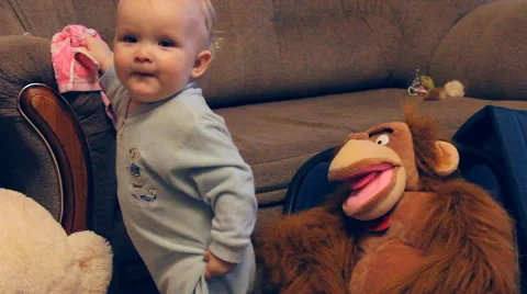 A child plays and monkey toy Stock Footage 47037033