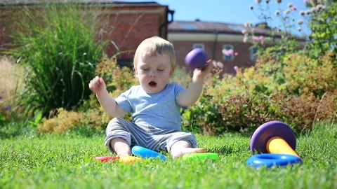 A child plays with a ball from a pyramid Stock Footage 137023958