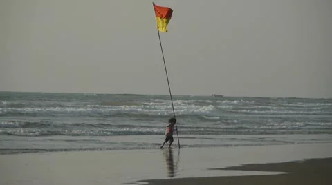 Child plays at a beach Stock Footage 10792083