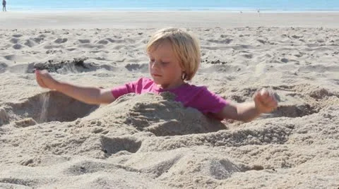 Child plays at the beach Stock Footage 12401237